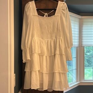 white ruffled dress lightly worn for sorority events